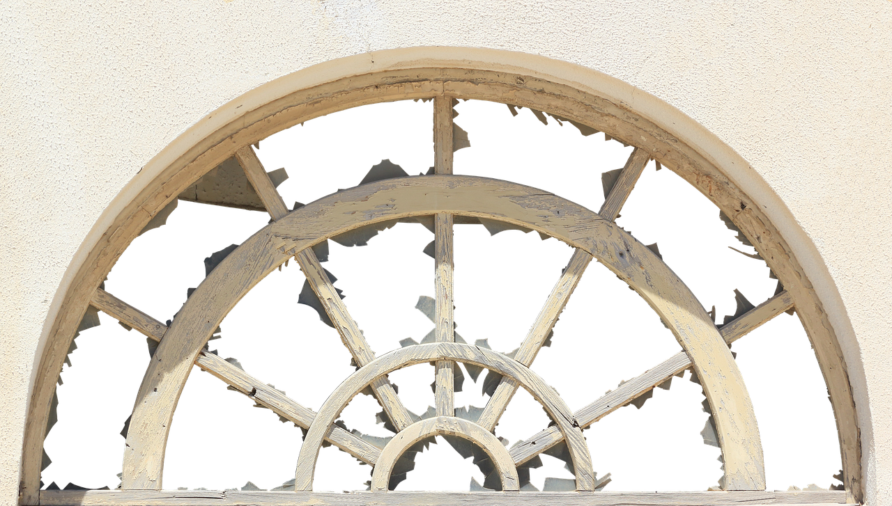 Arched Window With Wooden Wheel Decor