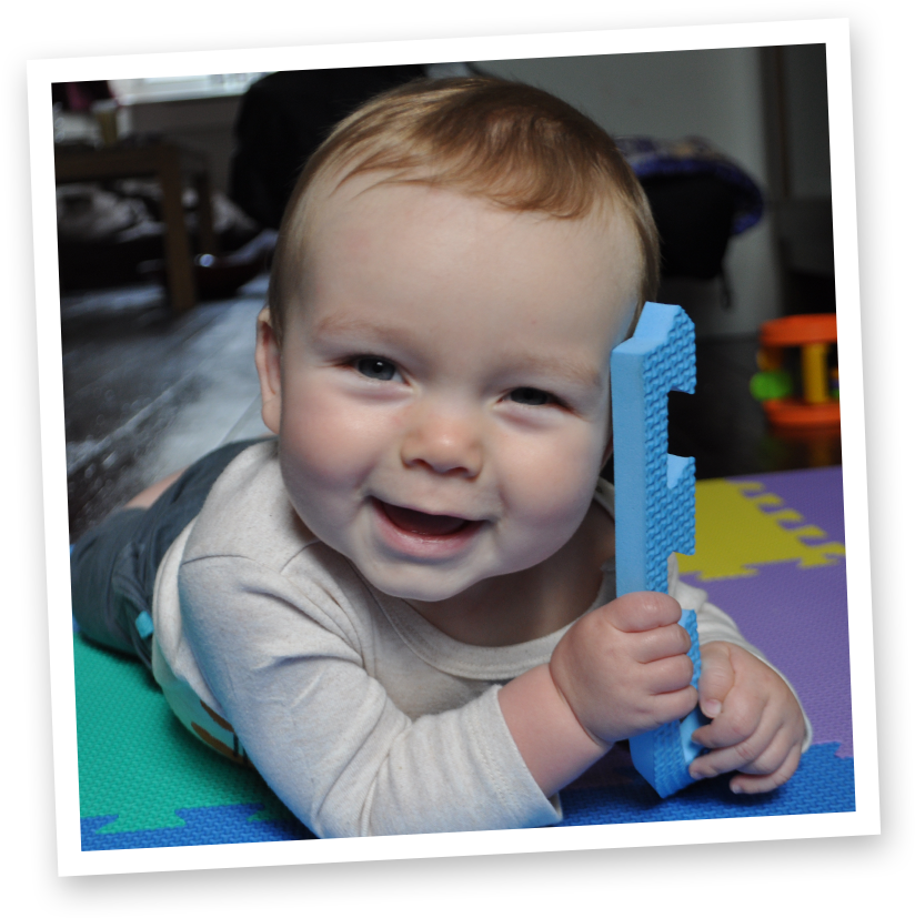 Happy Toddler With Toy Letter