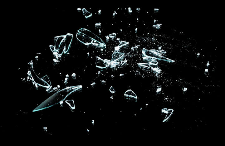 Shattered Glass Fragments Against Black Background