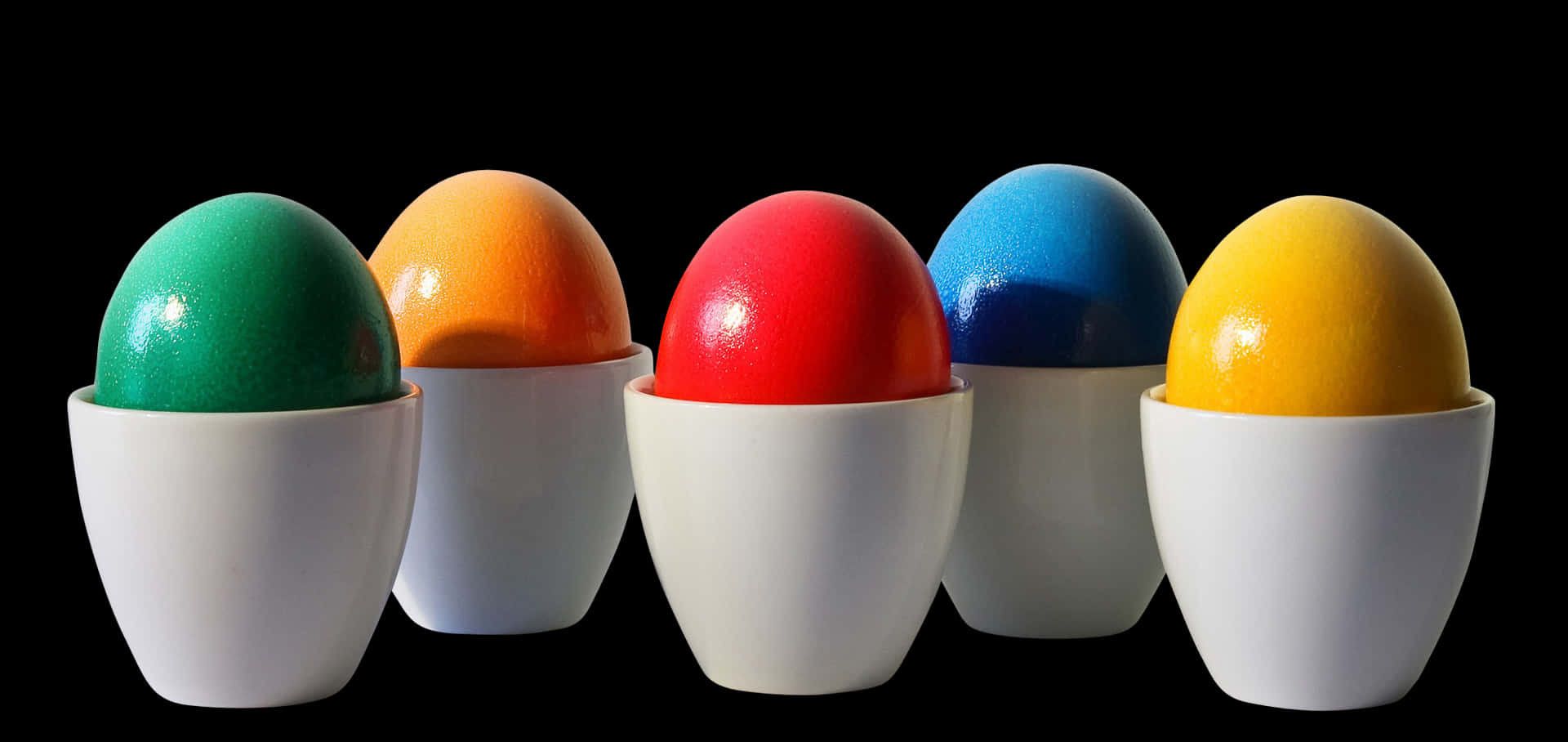 Colorful Eggsin Cupson Black Background PNG Image