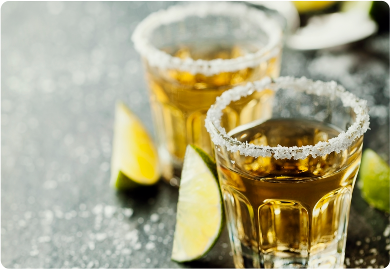 Salt Rimmed Tequila Shots With Lime Wedges PNG Image