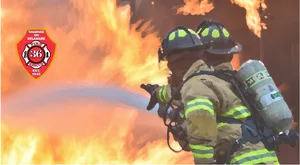 Firefighterin Action Extinguishing Blaze PNG Image