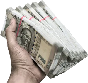 Hand Holding Indian Currency Bundles PNG Image