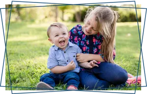 Joyful Siblings Playing Outdoors PNG Image