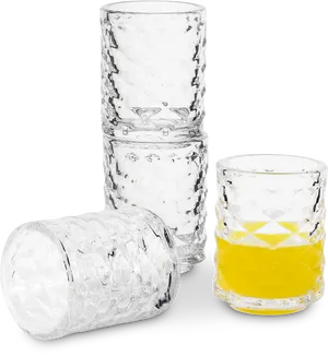 Stacked Crystal Glasses With Yellow Liquid PNG Image