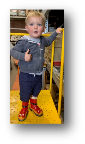 Toddler In Warehouse With Boots PNG Image